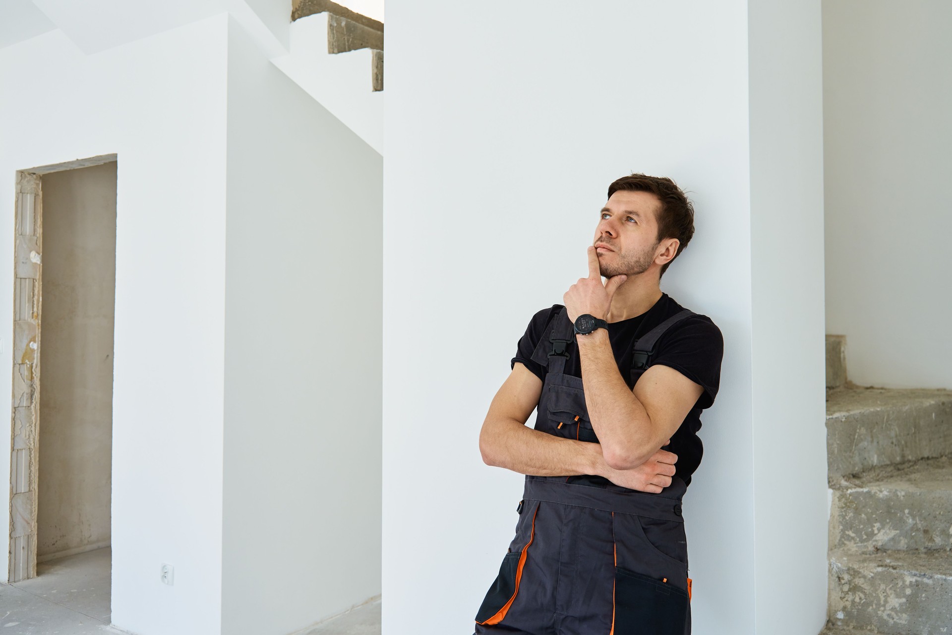 Professional construction worker in unfinished apartment